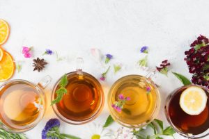 Cups of tea with herbs and spices