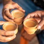 Drinking Chai tea with milk in earthen cups in India
